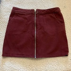 This is a burgundy skirt. Brand is unknown. This skirt is a small